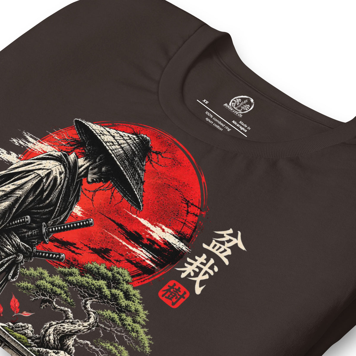 Close-up of samurai beside a green bonsai and red sun with Bonsai Life Co. lettering on dark brown T-shirt
