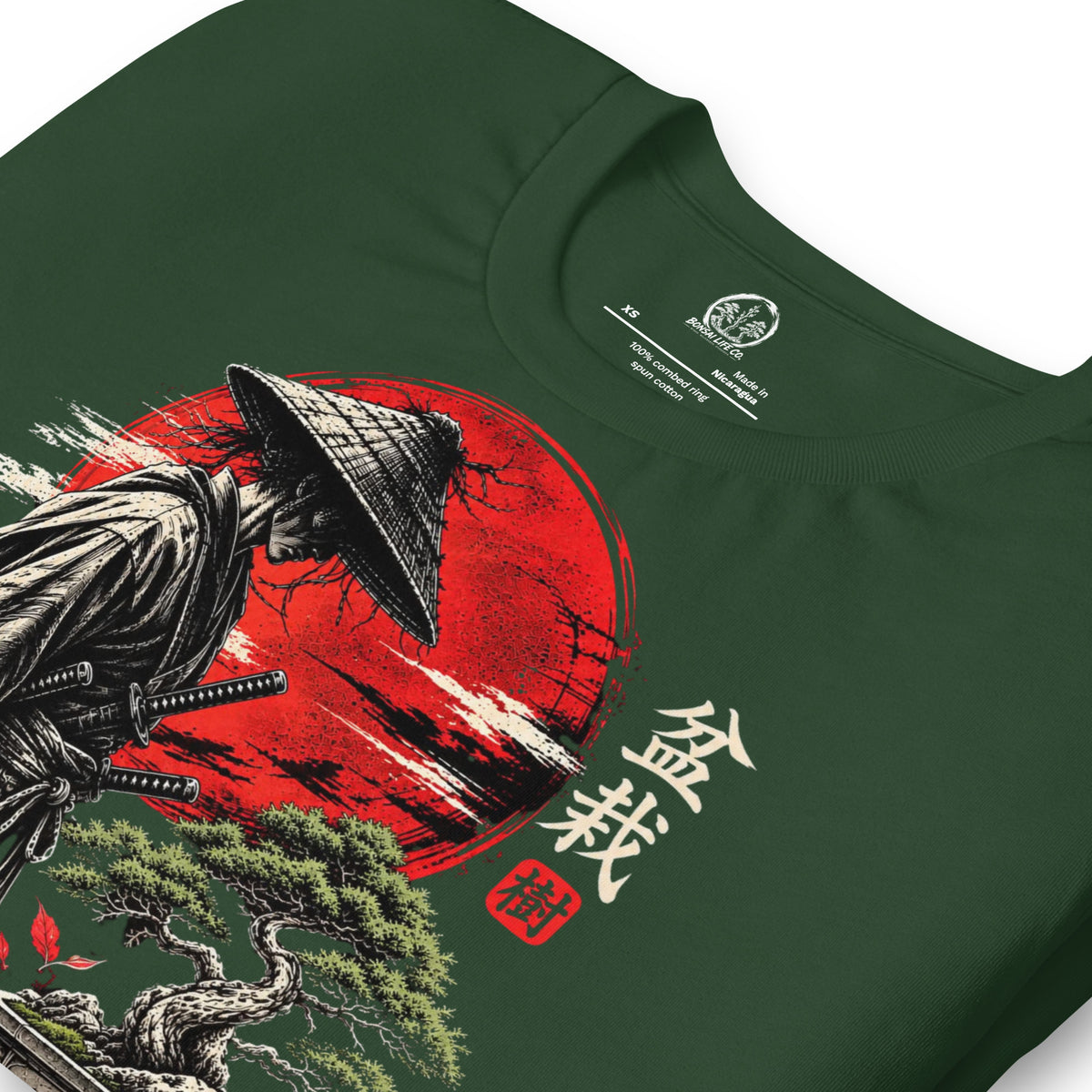 Close-up of samurai beside a green bonsai and red sun with Bonsai Life Co. lettering on forest green T-shirt