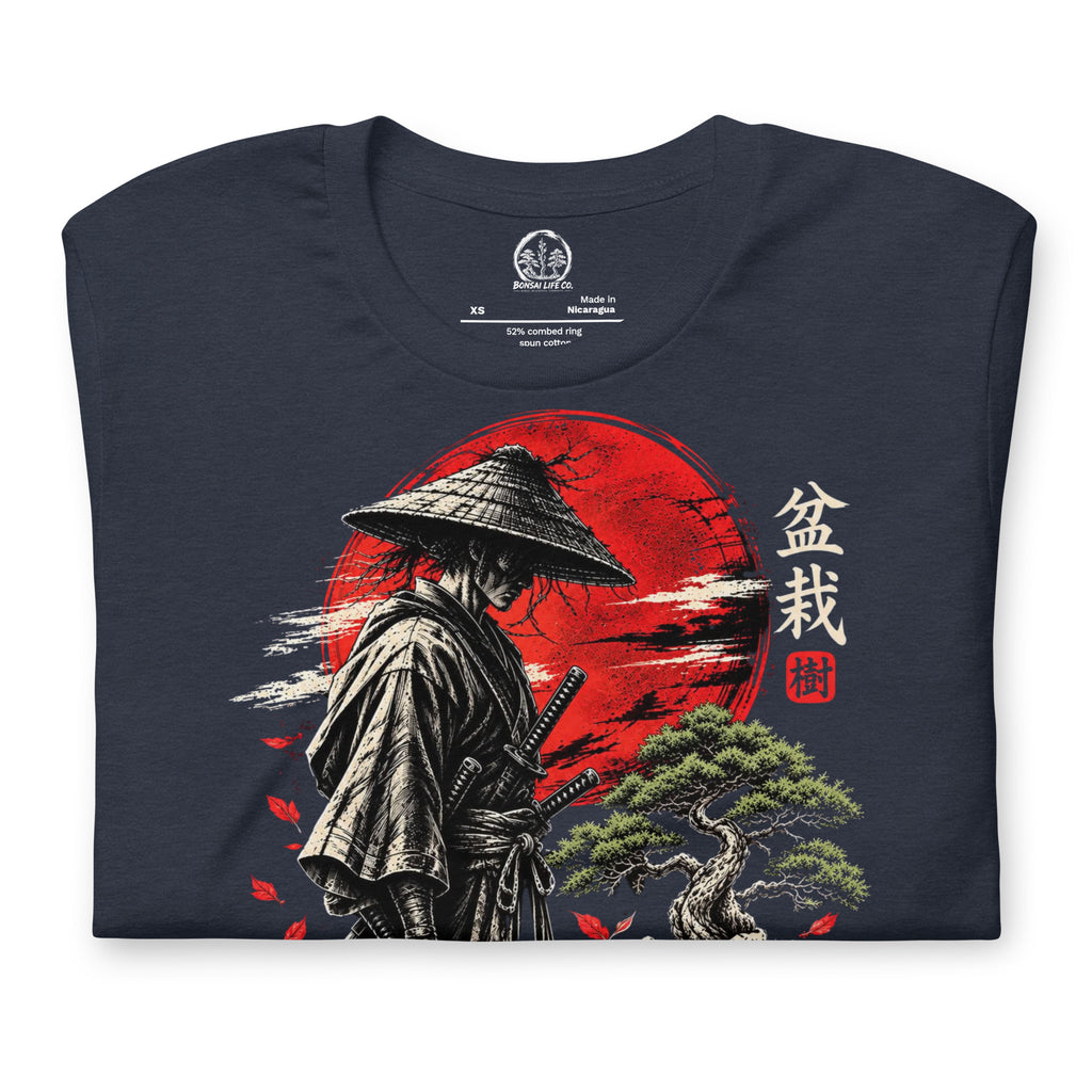 Folded heathered navy blue T-shirt showing samurai beside a green bonsai and red sun with Bonsai Life Co. lettering