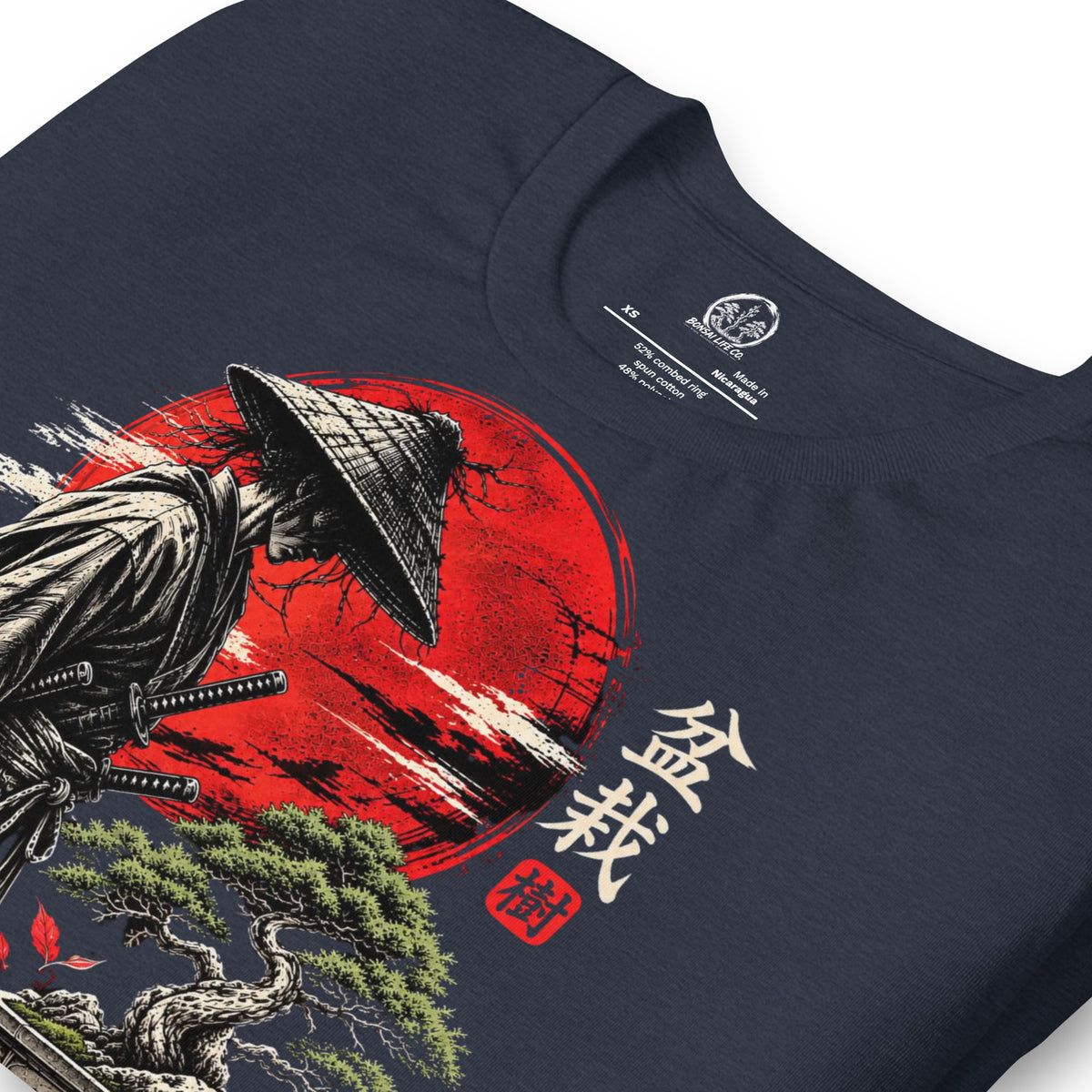 Close-up of samurai beside a green bonsai and red sun with Bonsai Life Co. lettering on heathered navy blue T-shirt