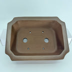 Top view of the brown rectangular pot showing two drainage holes and four smaller openings